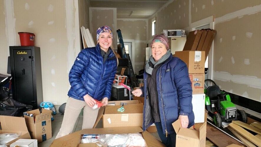 Anna and a volunteer packing .jpeg