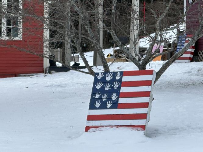 Hand-printed stars on the blue ground of a handmade wooden American flag