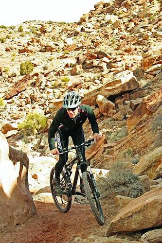 Wheel Family Fun - uphill or downhill - mountain biker between rocks
