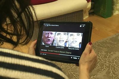 A woman views a manipulated video in January 2019 that changes what is said by President Donald Trump and former President Barack Obama, illustrating how deepfake technology can deceive viewers.