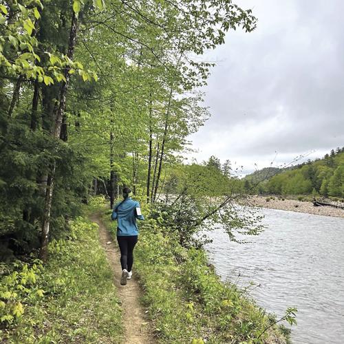 Wheel Family Fun - A runner runs along the riverside path from Thorne Pond