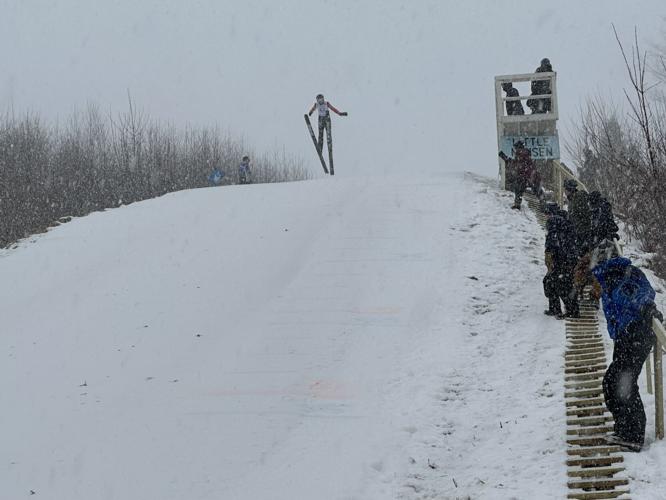 A skier takes flight from the Little Nansen 39M ski jump