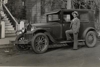 A Filipino man poses next to a Ford Model A in the 1930s. Filipino Agricultural Workers Collection, Archives Center, National Museum of American History