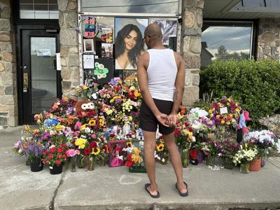 A man stands at the tribute for Marisol Fuentes at La Casita restaurant in Berlin
