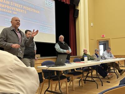 Peter Gagnon (at left, standing) makes a point during a May 11 discussion