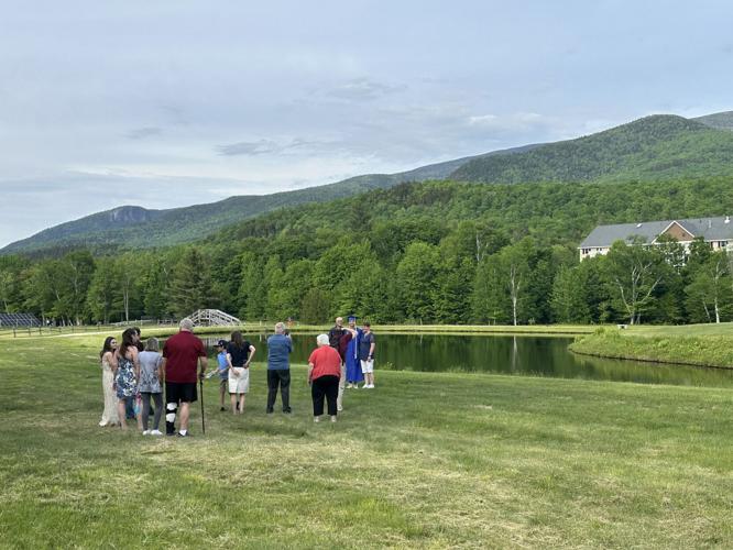 A family takes picture of a newly minted Gorham High School graduate