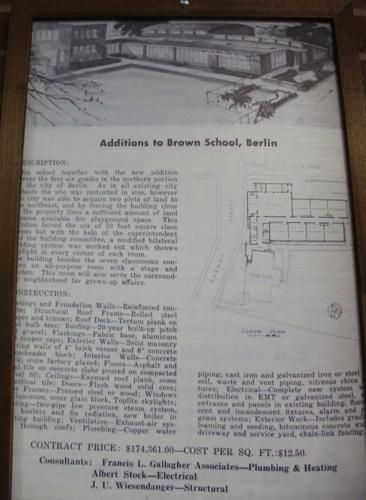 A plaque on the wall in the Brown School apartment building
