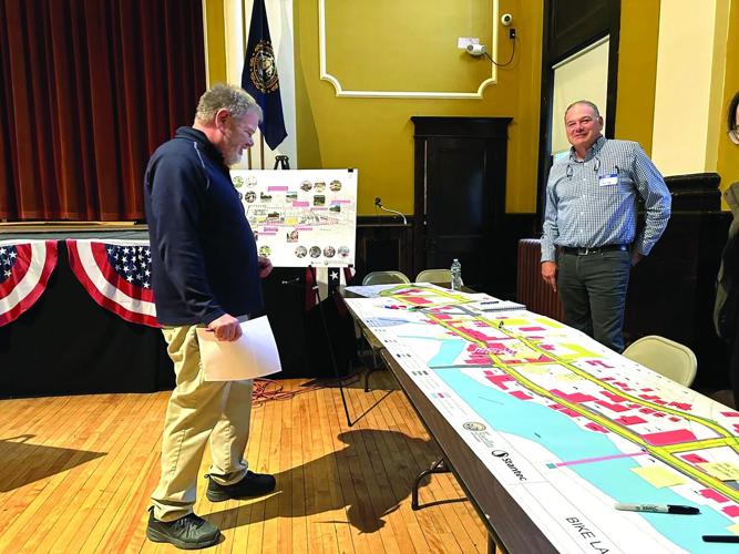 A visitor at the evening session of the Oct. 15 downtown project update chats with Bob Corning