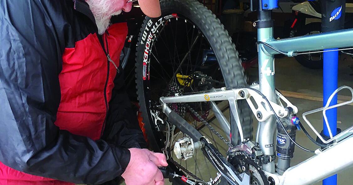 Wheel Family Fun - bike safety - Peter Minnich works on a bike