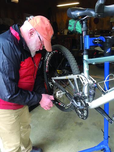 Wheel Family Fun - bike safety - Peter Minnich works on a bike
