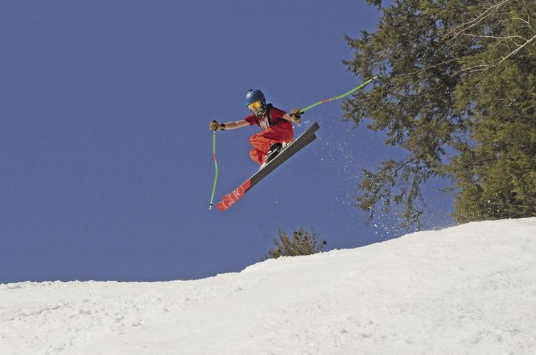 skier jump into blue sky
