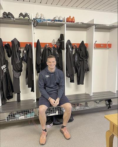 Camden Clark in front of locker