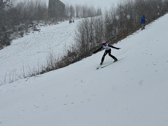A skier directs the skis to slow down
