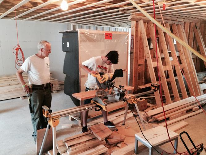 Habitat volunteers work converting a North Road condo