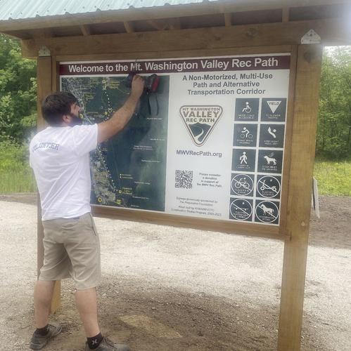 Wheel Family Fun - Ben Colbath of Gemini Signs installs new sign at MWV Rec Path kiosk