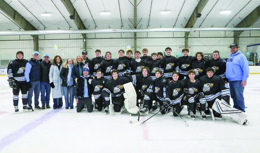 02-14-26 KHS Hockey Fights Cancer team with board smiles