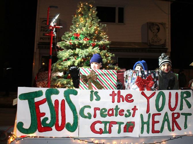 A holy-themed float features smiling children in the Nov. 29 Parade of Lights