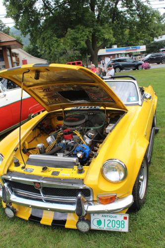 A canary yellow MG convertible with a V8 engine