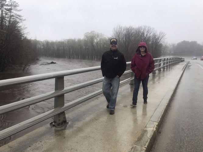 couple by high water under bridge