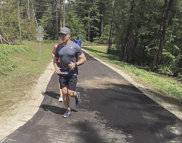 Wheel Family Fun - faster runner passes another trail user
