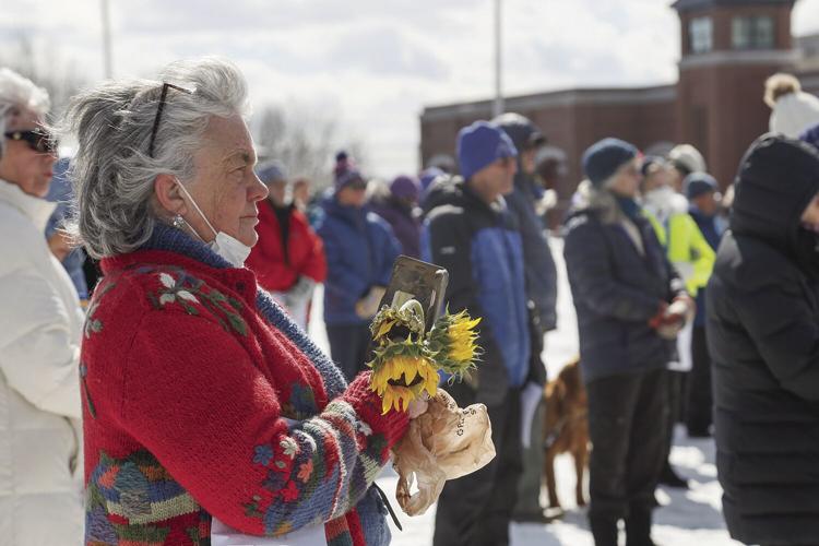 03-13-22 Ukraine Vigil holding sunflowers