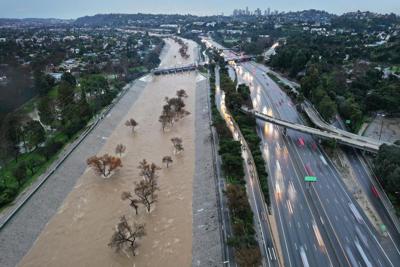 Heavy rain from an atmospheric river sent the Los Angeles River, normally mostly empty, spilling over its sides in February 2024.