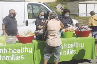 Residents pick up fresh fruits and vegetables