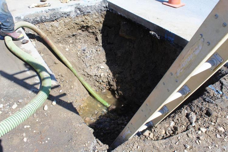 A water line break under Main Street in Gorham is being pumped out