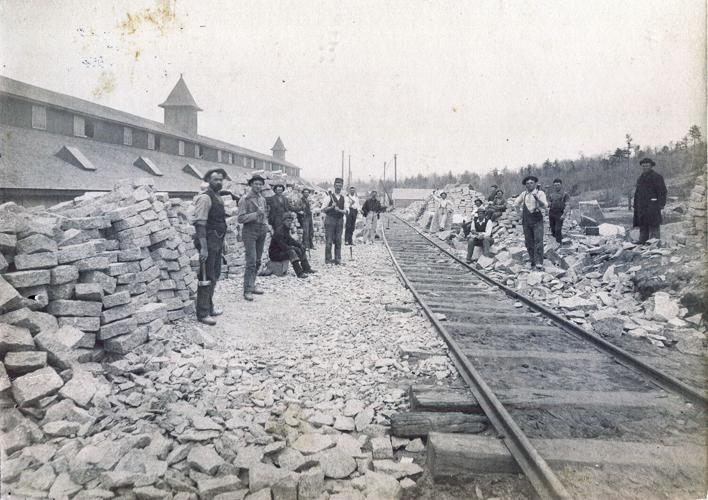 workers by shed and paving blocks