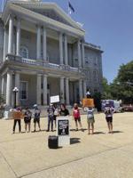 Climate activists rally at State House In oppressive heat