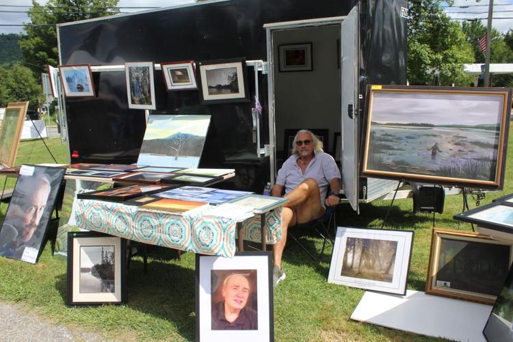 Gordie Roberge sits poised to answer any questions about the painting and photographs