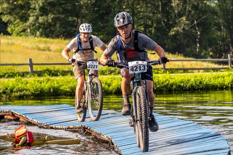 Racers challenge themselves over the floating bridge with ever threatening "Tick-Tock the Croc."