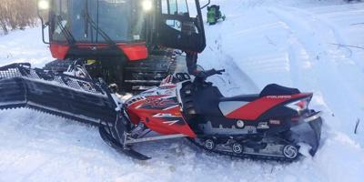 Woman jumps off snowmobile to avoid crash