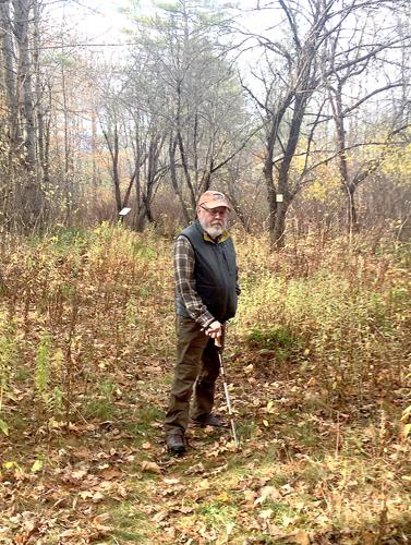 Wheel Family Fun - Peter Minnich walks among the apple trees revealed on Kissing Brook Trail