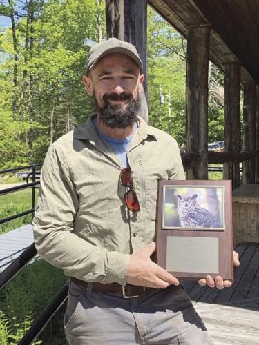 recon trail design guy with plaque