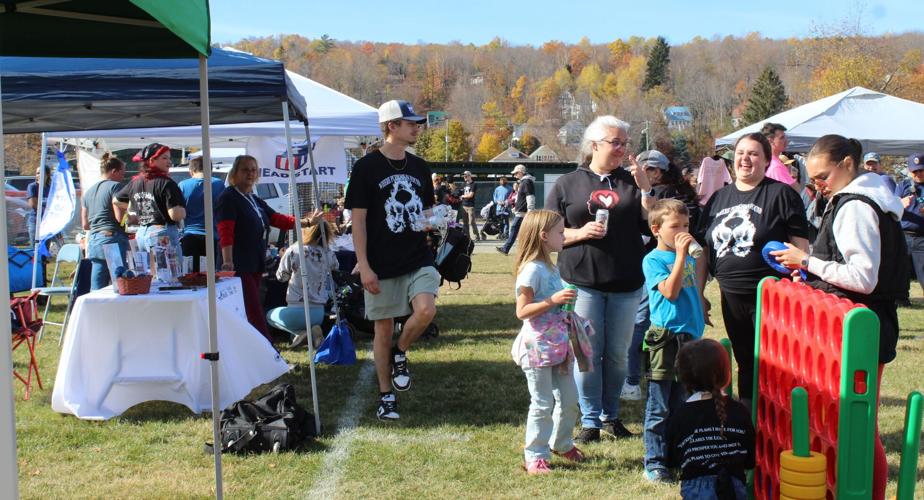 Kids and adults relax at Horne Field where social service agencies offered brochures