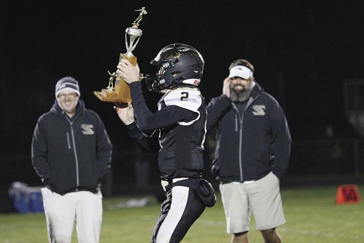 10-29-21 KHS FB holding up trophy