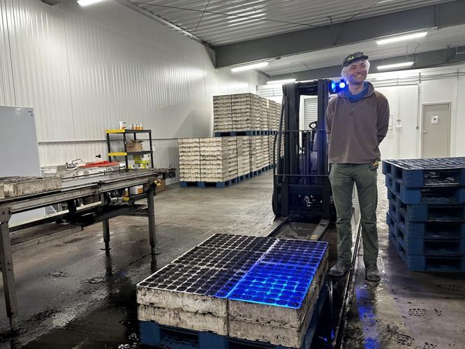 North Country Growers Project Manager Jack Daley stands in front of pallets