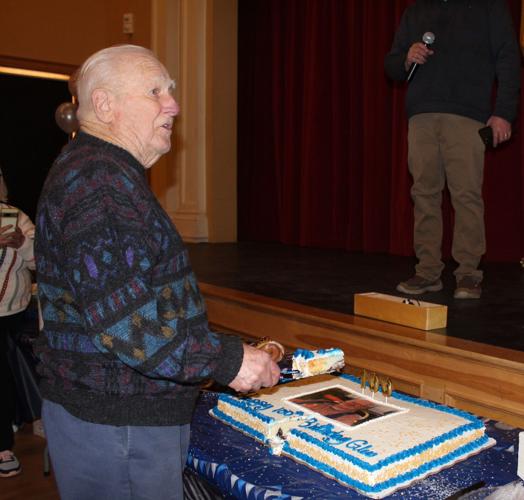 Glen Eastman cuts a slice of his birthday cake