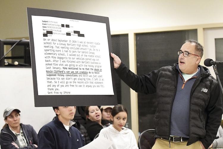 Conway School Board - hockey - Kevin Clifford with sign