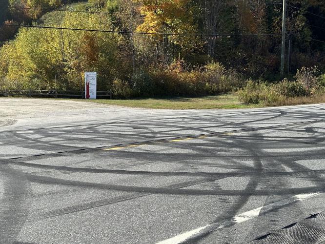 Road surface damage in the foreground on Route 16 at the Nansen ski jump site entrance.