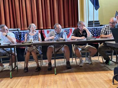 Councilor Brian Valerino (second from right) listens to a discussion
