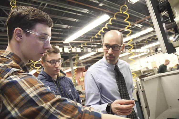 NASA HUNCH - Andy Shaw and two students in shop