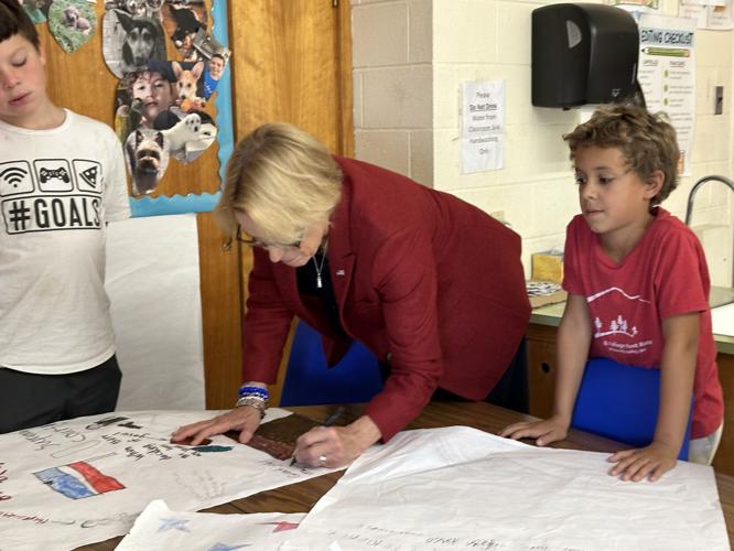 U.S. Sen. Maggie Hassan (D-N.H.) signs student-drawn posters