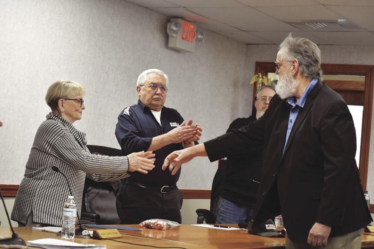 Hounsell shaking hands