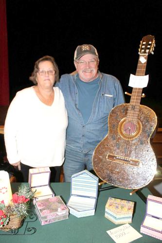 Susan and Gordon Young, who holds a guitar refashioned as a functioning clock