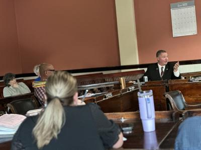 Councilor Brian Valerino (right background) makes a point during the June 2 city council discussion