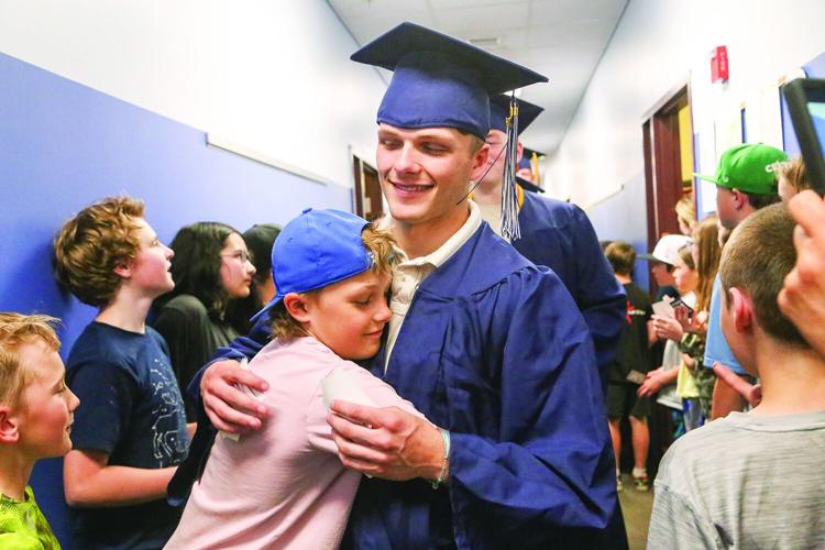 05-20-26 FA Grad Woodland Walk hallway hug