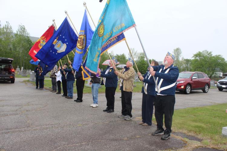A color guard lines up for a Memorial Day observance at the Holy Family Cemetery