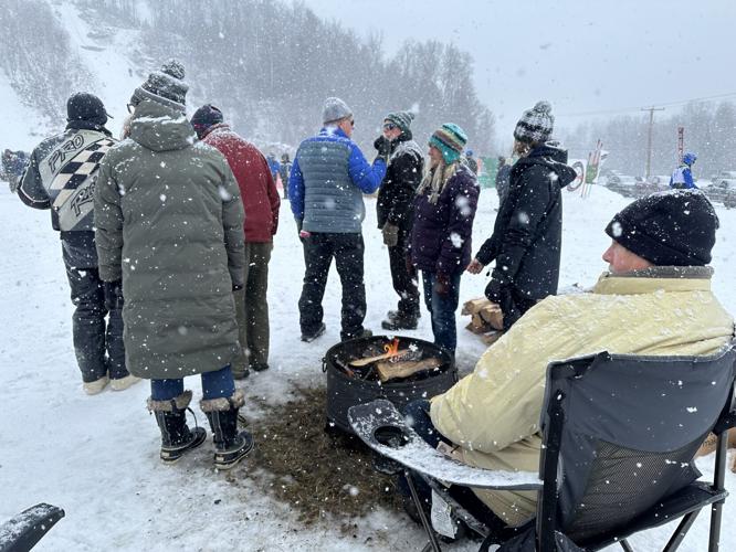 A fire pit keeps visitors at the Nansen Ski Jump warm Jan. 26